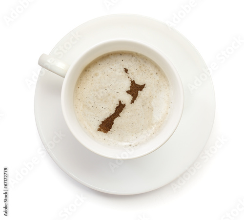 Cup of coffee with foam and powder in the shape of New Zealand.(