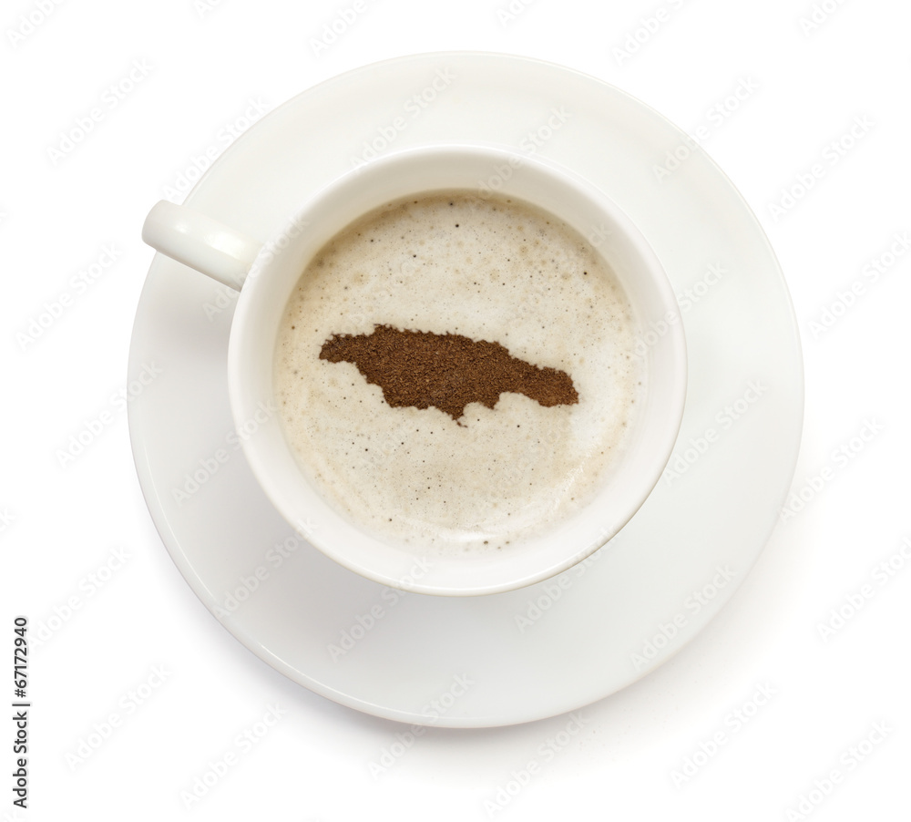 Cup of coffee with foam and powder in the shape of Jamaica.(seri Cup of coffee with foam and powder in the shape of Jamaica.(seri