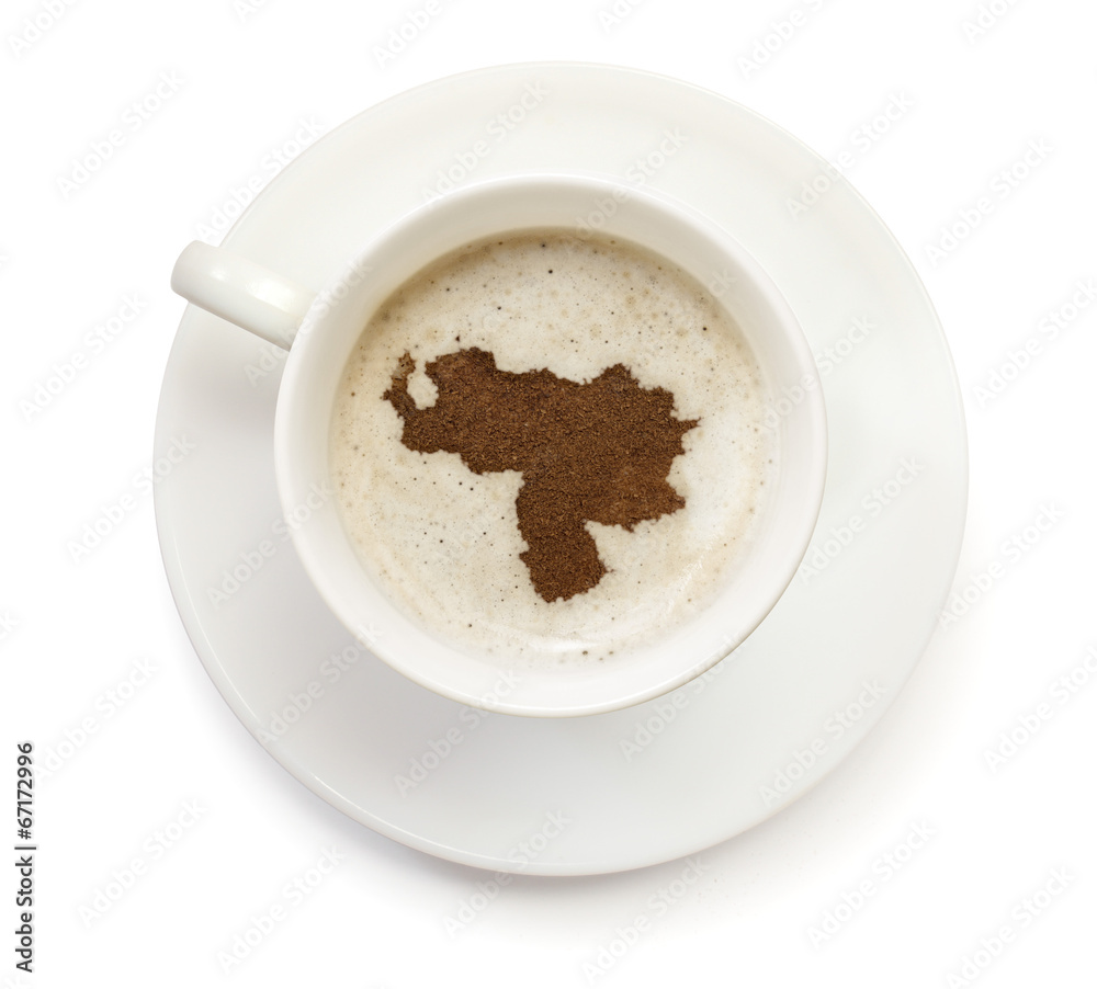 Cup of coffee with foam and powder in the shape of Venezuela.(se Cup of coffee with foam and powder in the shape of Venezuela.(se