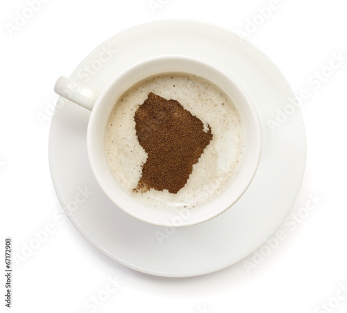 Cup of coffee with foam and powder in the shape of French Guiana