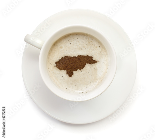 Cup of coffee with foam and powder in the shape of Honduras. ser