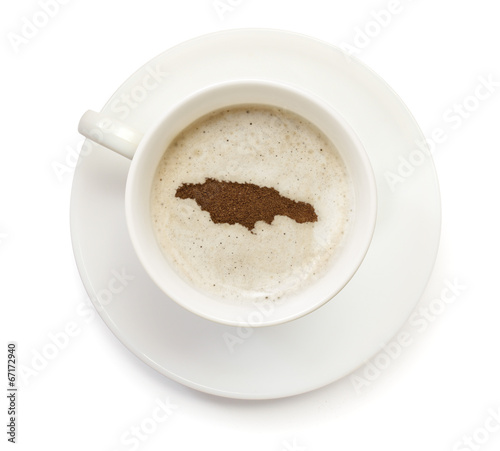 Cup of coffee with foam and powder in the shape of Jamaica.(seri