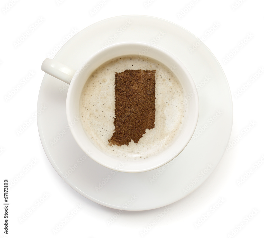 Cup of coffee with foam and powder in the shape of Indiana.(seri Cup of coffee with foam and powder in the shape of Indiana.(seri