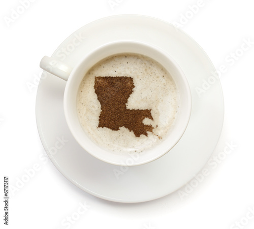 Cup of coffee with foam and powder in the shape of Louisiana.(se