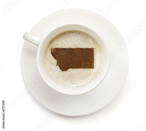 Cup of coffee with foam and powder in the shape of Montana.(seri