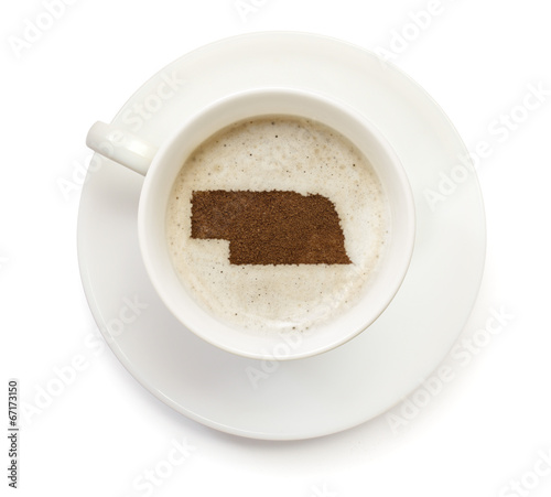 Cup of coffee with foam and powder in the shape of Nebraska.(ser