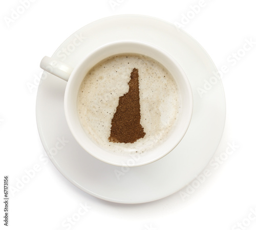 Cup of coffee with foam and powder in the shape of New Hampshire