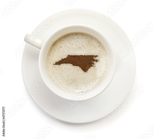 Cup of coffee with foam and powder in the shape of North Carolin
