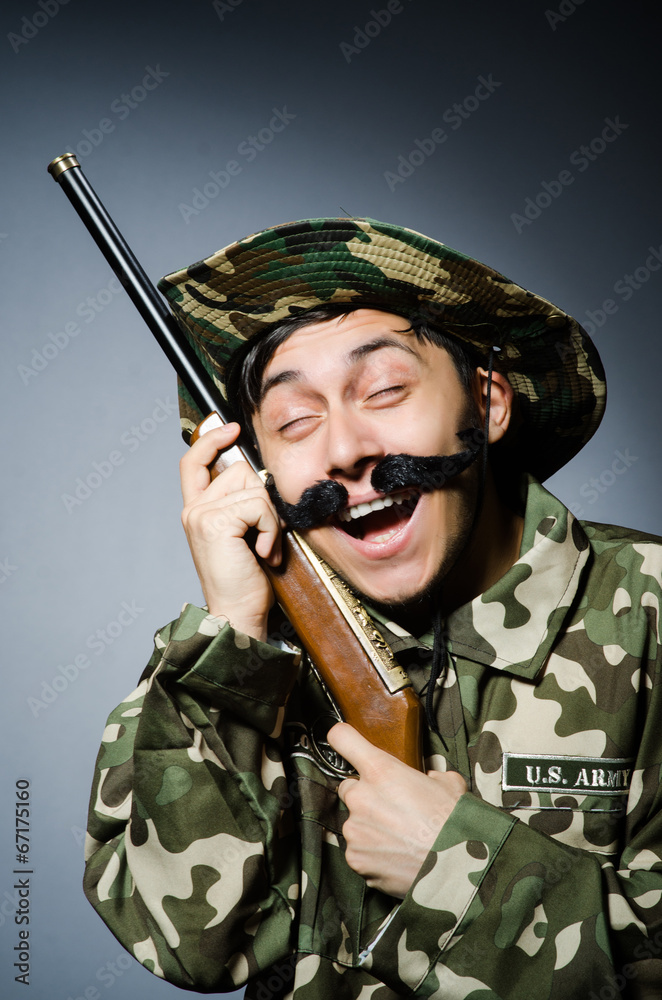 Fototapeta premium Funny soldier against the dark background