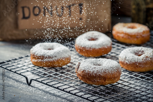 Billede på lærred Donuts decorated with icing sugar