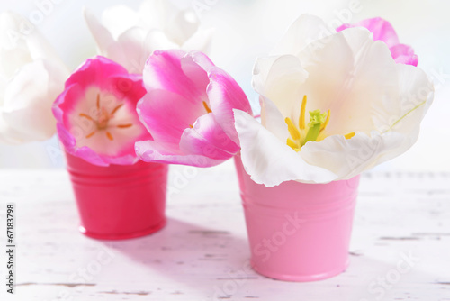 Fototapeta Naklejka Na Ścianę i Meble -  Beautiful tulips in bucket on table on light background