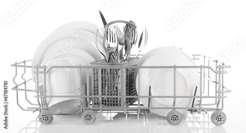 Clean dishes drying on metal dish rack, isolated on white
