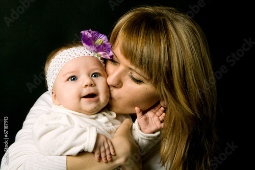 mother kissing baby
