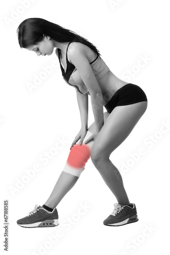 Athletic young woman with elastic bandage on his leg. Isolated