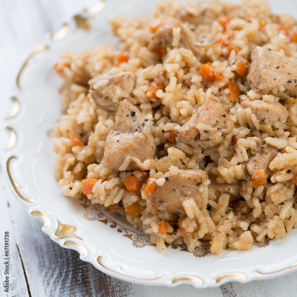 Close-up of pilaf with chicken in a glass plate, studio shot Close-up of pilaf with chicken in a glass plate, studio shot