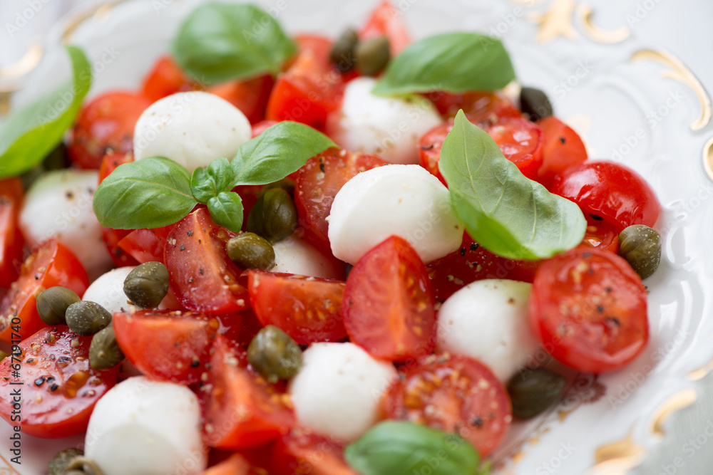 Caprese salad with capers, studio shot, close-up
