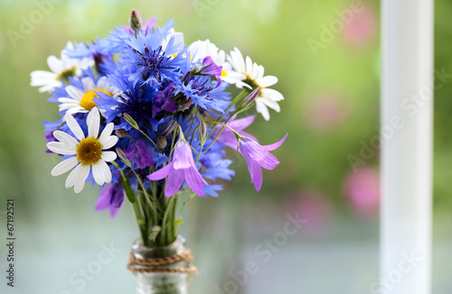 Fototapeta Naklejka Na Ścianę i Meble -  bouquet made of wildflowers on windowsill