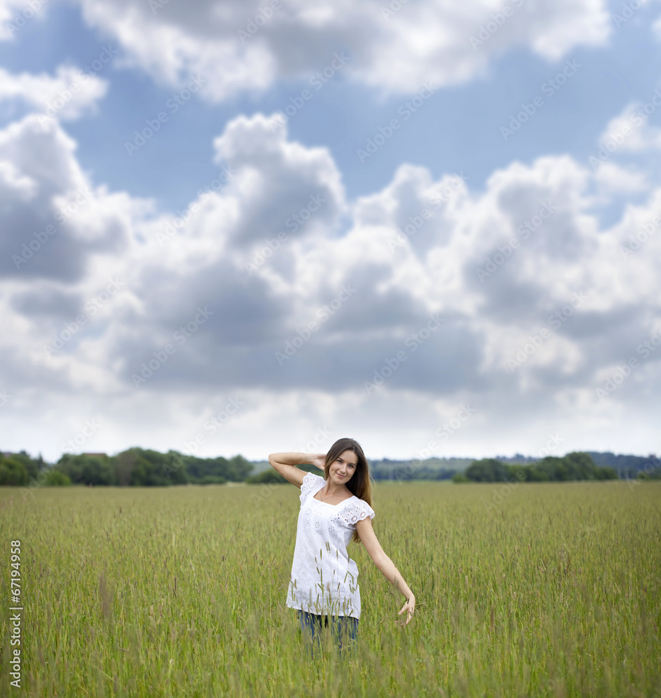 Young woman walks in summer field Young woman walks in summer field
