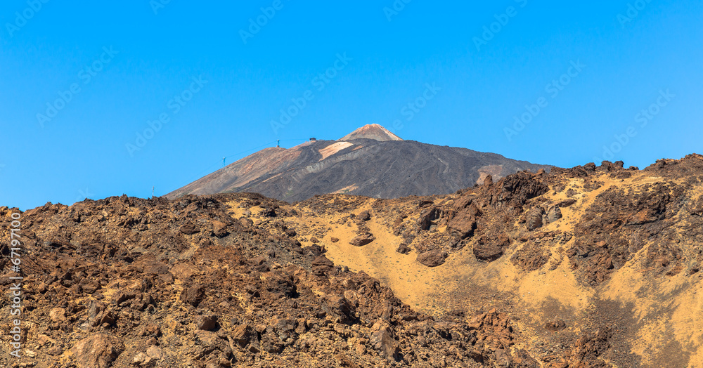 Teide volcano beyond volcanic rocks in Tenerife