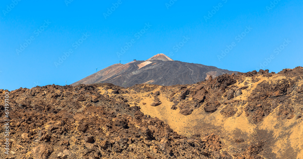 Teide volcano beyond volcanic rocks in Tenerife Teide volcano beyond volcanic rocks in Tenerife