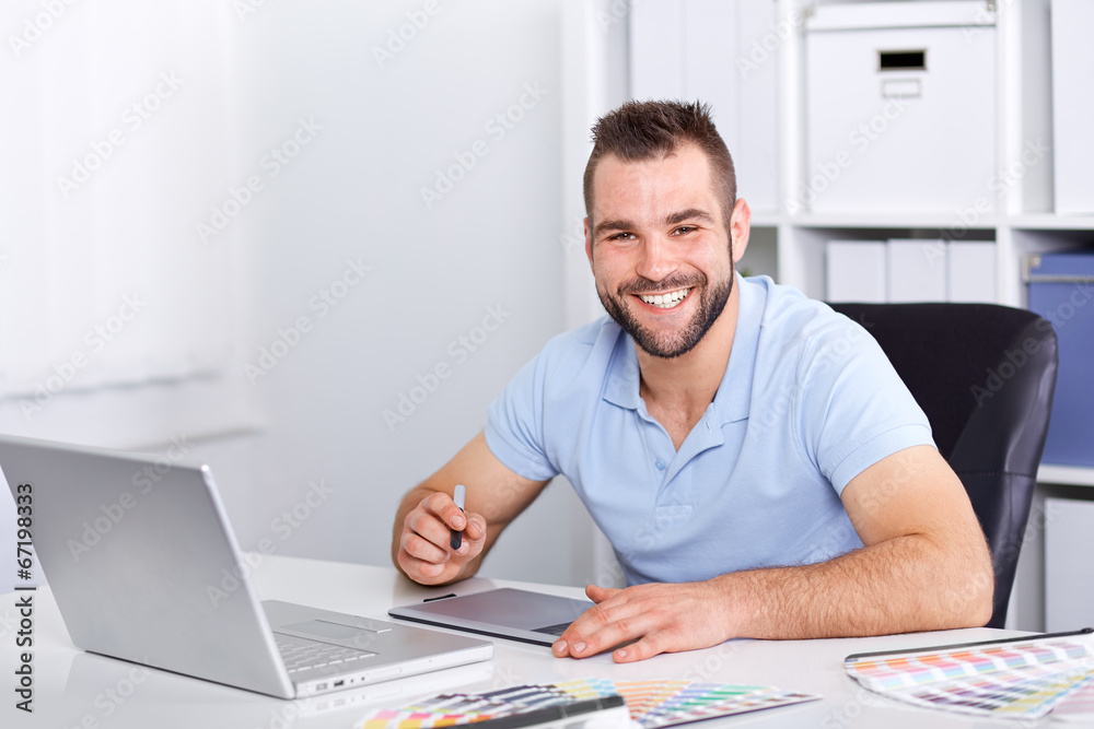 Graphic designer using a graphics tablet in a modern office Graphic designer using a graphics tablet in a modern office