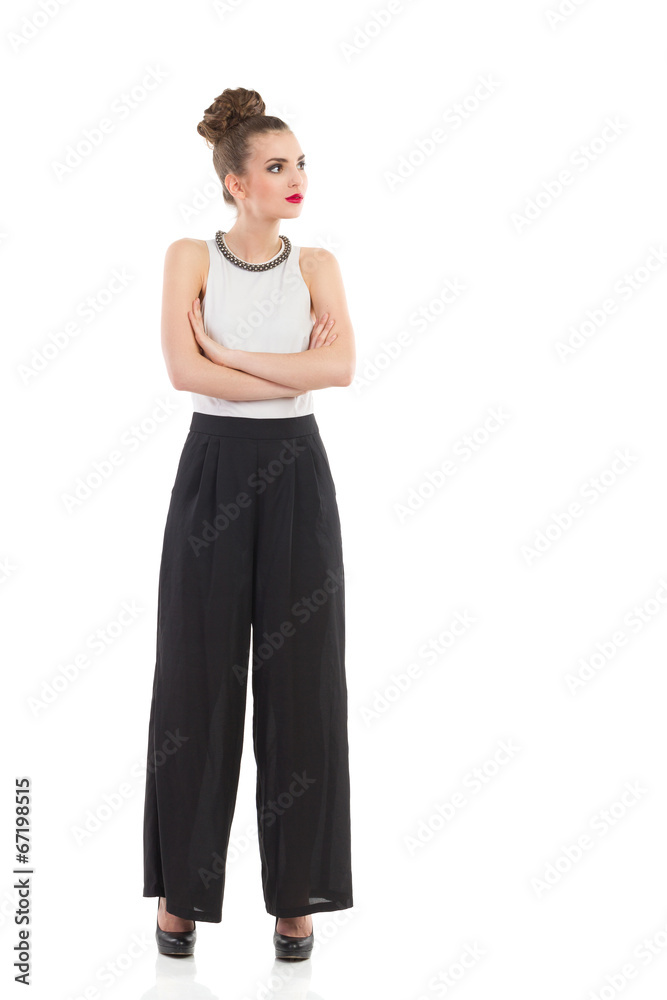 Elegance fashion model is posing with arms crossed. Elegance fashion model is posing with arms crossed.