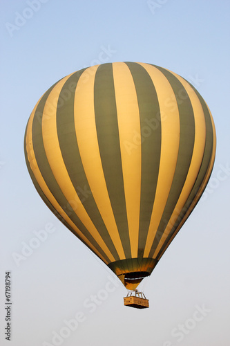 Flying green and yellow hot air balloon