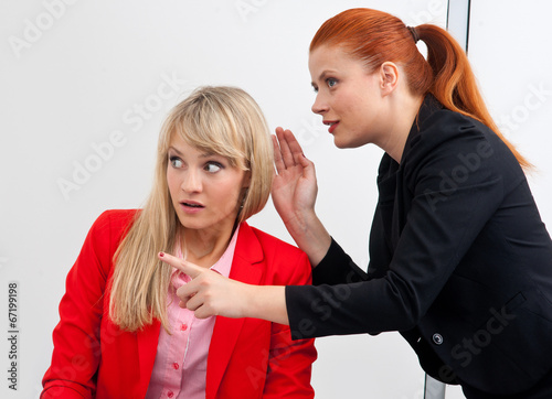 two woman colegues gossip in office photo