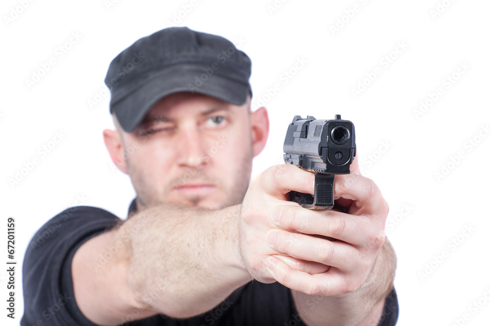 Man pointing gun, isolated on white. Focus on the gun Man pointing gun, isolated on white. Focus on the gun