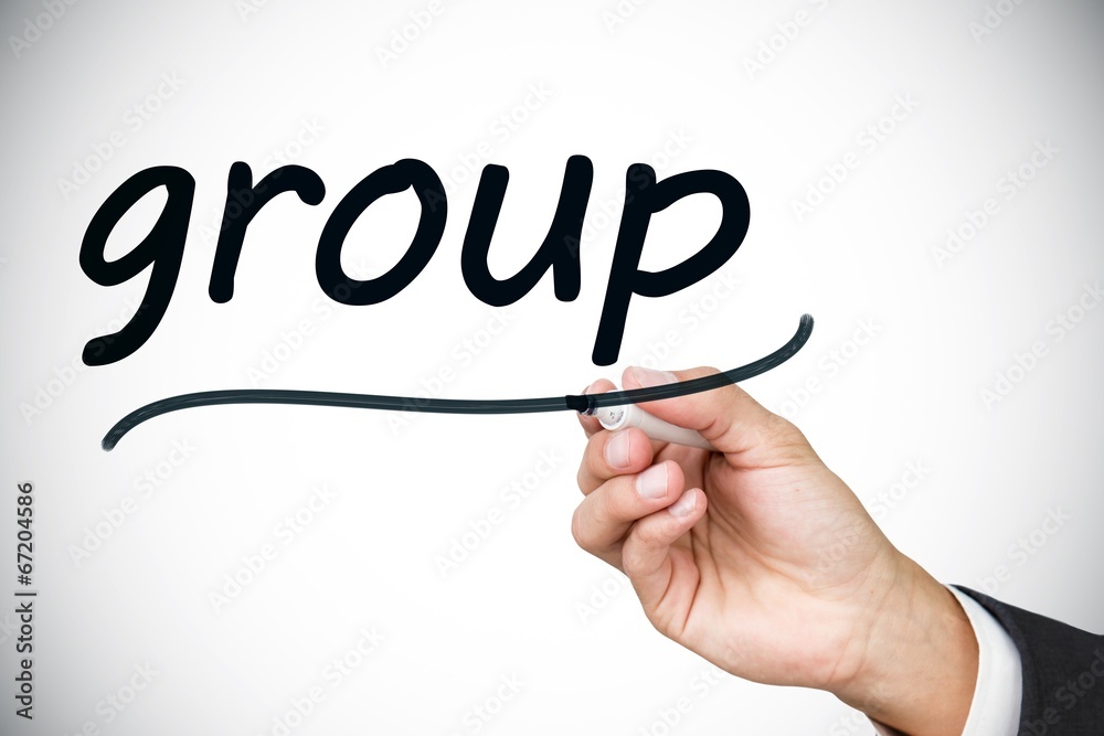 Businessman writing the word group Businessman writing the word group