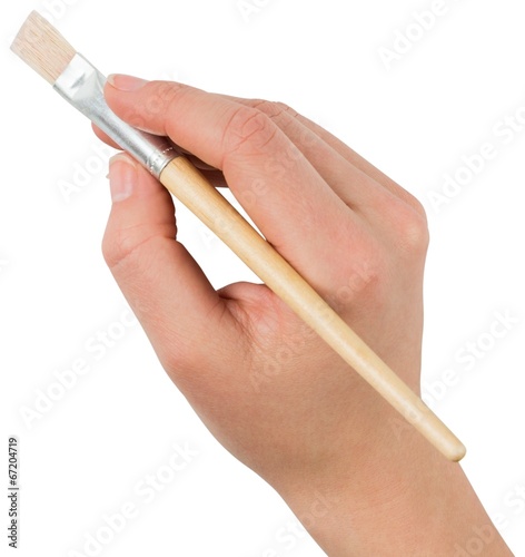Hand holding paintbrush