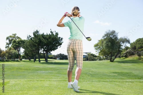 Female golfer taking a shot