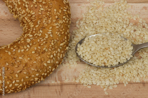 Close-up image of a bagel bread with sesame seeds in spoon