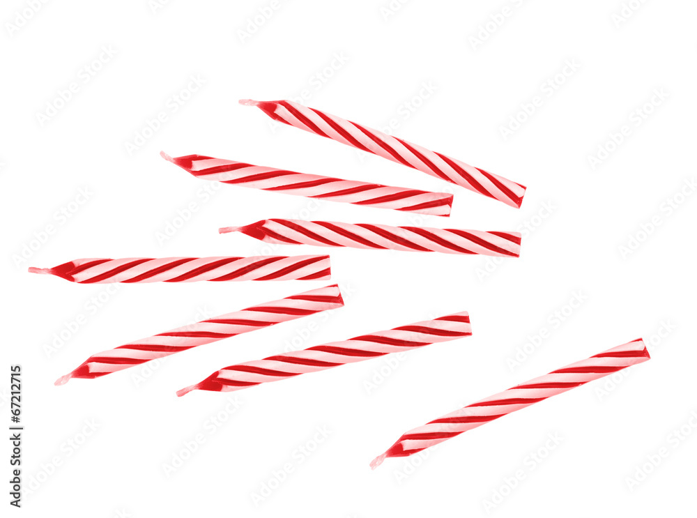 Red and white candy stripe birthday cake candles. Isolated. Red and white candy stripe birthday cake candles. Isolated.
