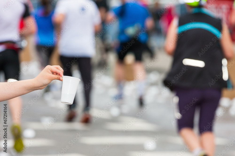 Marathon runner picking up water at service point