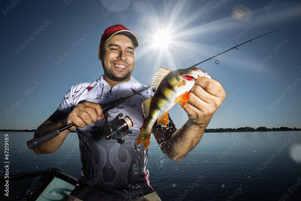 Happy angler with perch fishing trophy - obrazy, fototapety, plakaty 