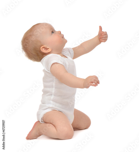 Infant child baby toddler smiling with hand thumb up sign