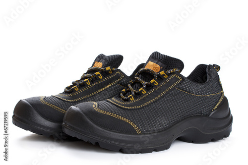 Black working boots with yellow thread on white