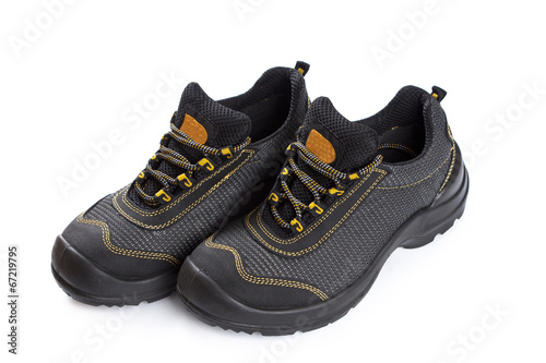 Black working boots with yellow thread on white