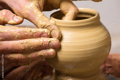 hands of a potter, creating an earthen jar