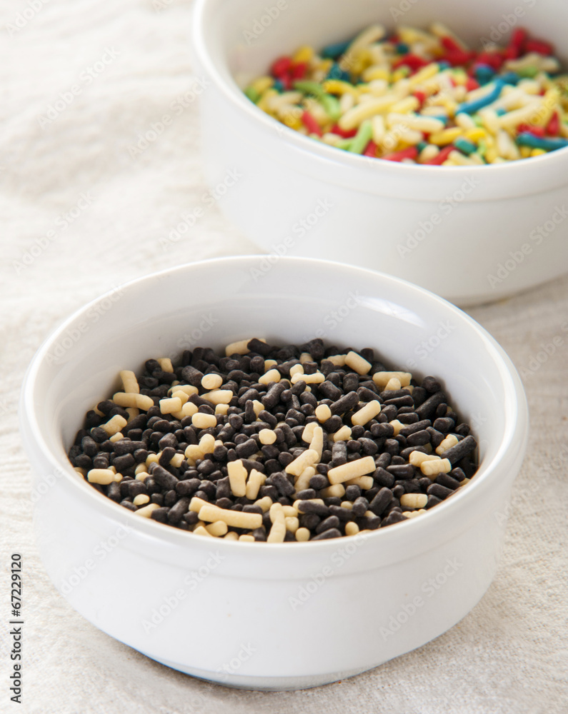 Chocolate sprinkles on white background close up Chocolate sprinkles on white background close up