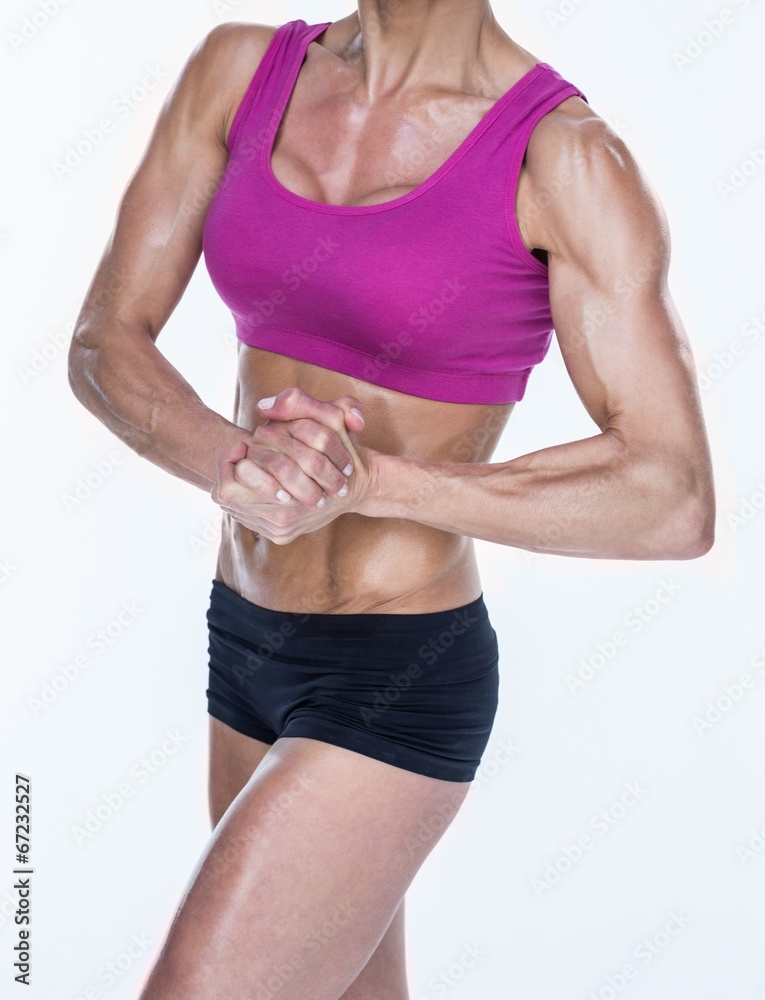 Female bodybuilder posing with hands together Female bodybuilder posing with hands together