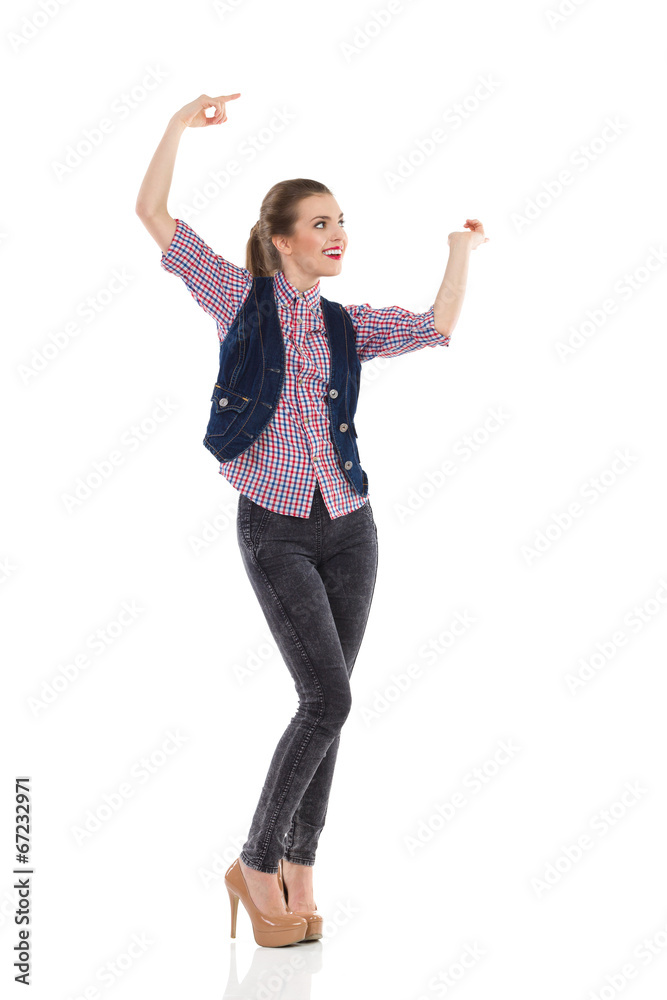 Smiling girl pointing and looking away. Smiling girl pointing and looking away.