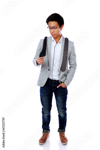 Asian man trying to choose a tie over white background photo