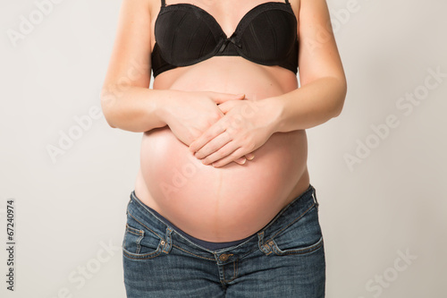 Pregnant woman with hands on her belly