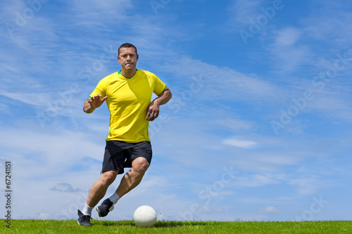 Brazilian soccer football player training on a grass pitch