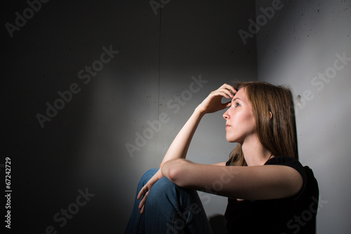 Young woman suffering from a severe depression photo