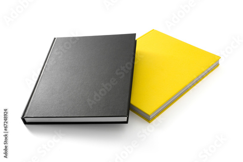 Two books (yellow and black) with blank covers isolated on white