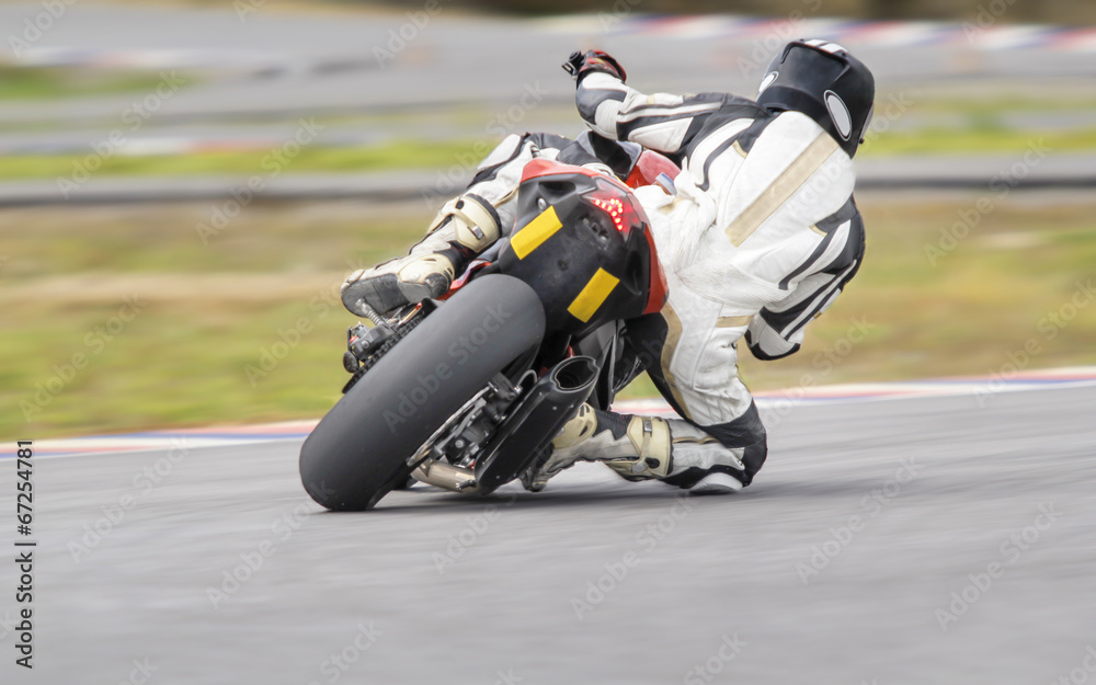 Motorcycle practice leaning into a fast corner on track