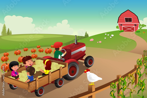 Kids on a hayride in a farm during Fall season